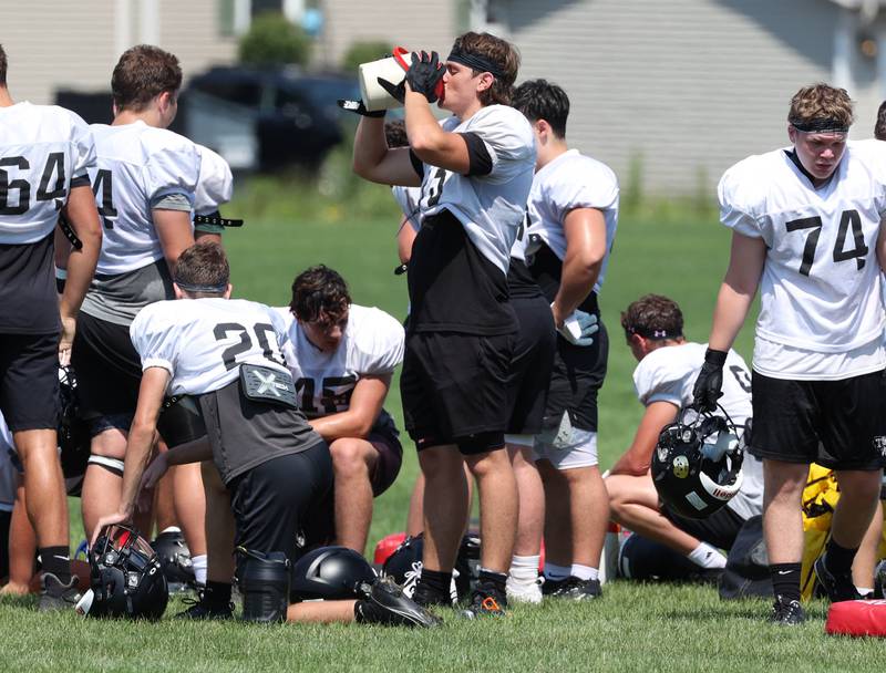 Sycamore players take a water break as temperatures climbed into the 90’s Monday, July 15, 2024, during summer football camp at Sycamore High School.