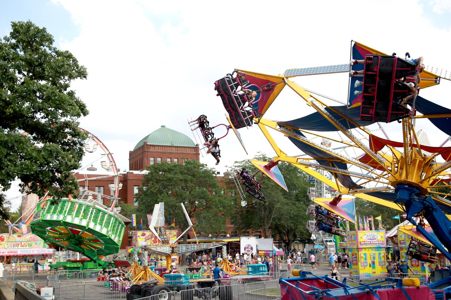 Carnival riders fly through the air on opening day of Swedish Days in Geneva on Wednesday, June 19, 2024.