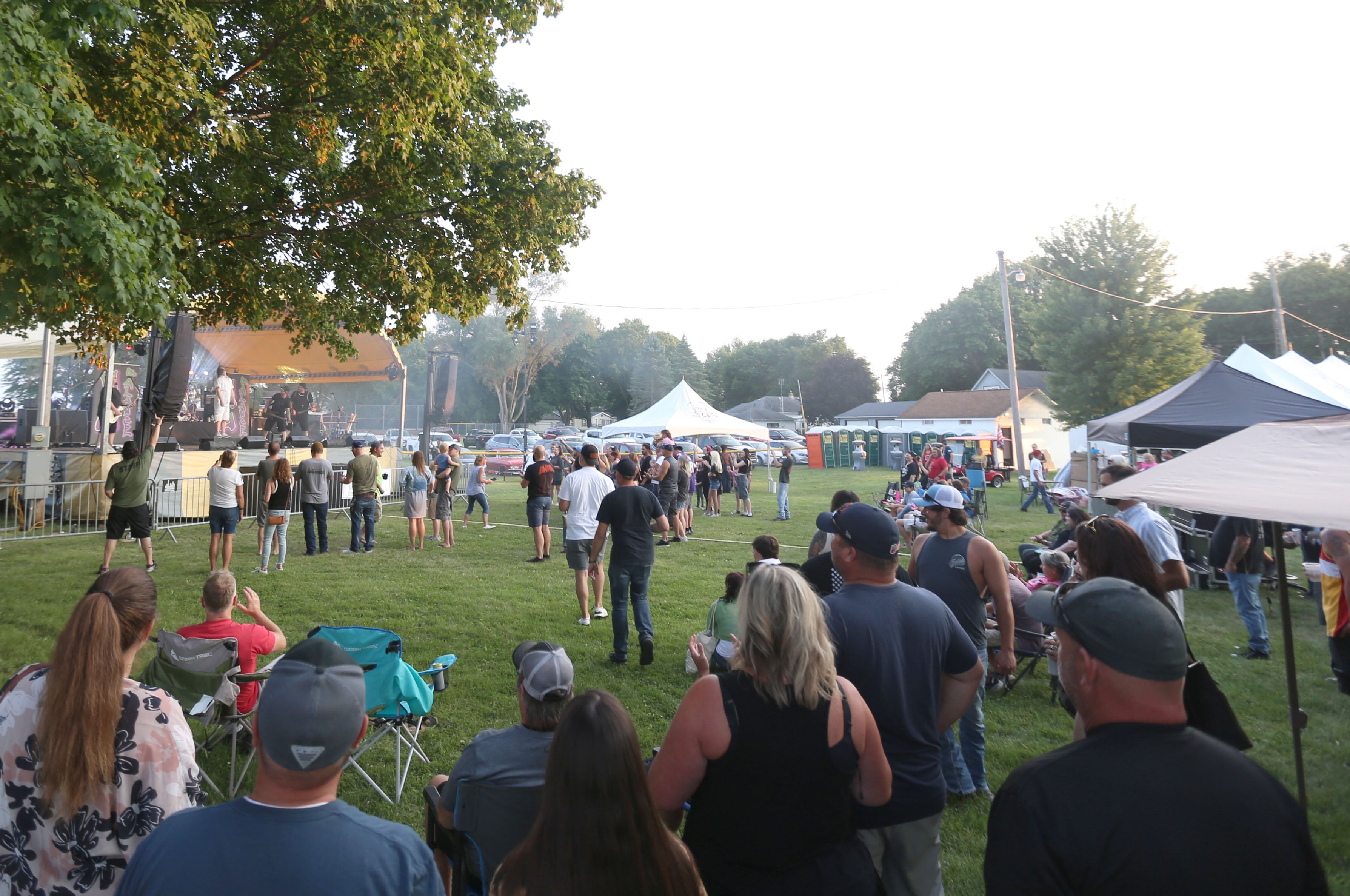 People listen to the band Nu Balance during the Cops 4 Cancer fundraiser on Friday, July 26, 2024 at Cerri Memorial Park in Cedar Point. Cops 4 Cancer began in 2003. The group helps families in their fight against cancer, by providing financial assistance in a variety of ways.