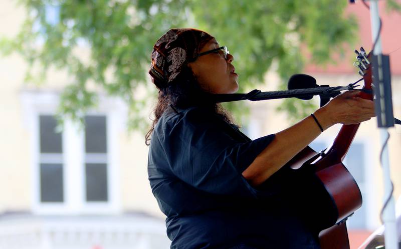 Musician Ivy Noemi entertains as part of The Dole Farmers Market in Crystal Lake Sunday.