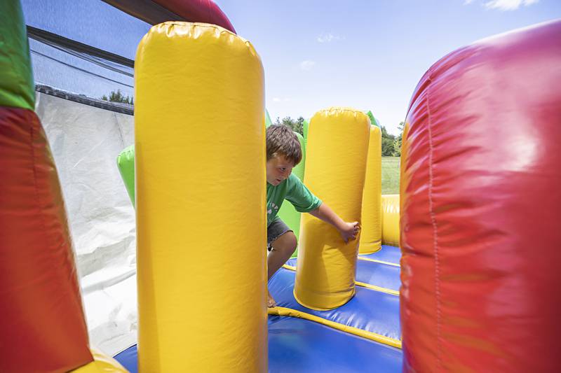 Weston Hollaway, 7, fights through an obstacle course Thursday, July 20, 2023 at Centennial Park in Rock Falls. Thursday marked the final day of the field trip program through the Coloma Park District. Throughout the summer campers visited museums, parks and what seems to have been a kid favorite, a bowling alley.