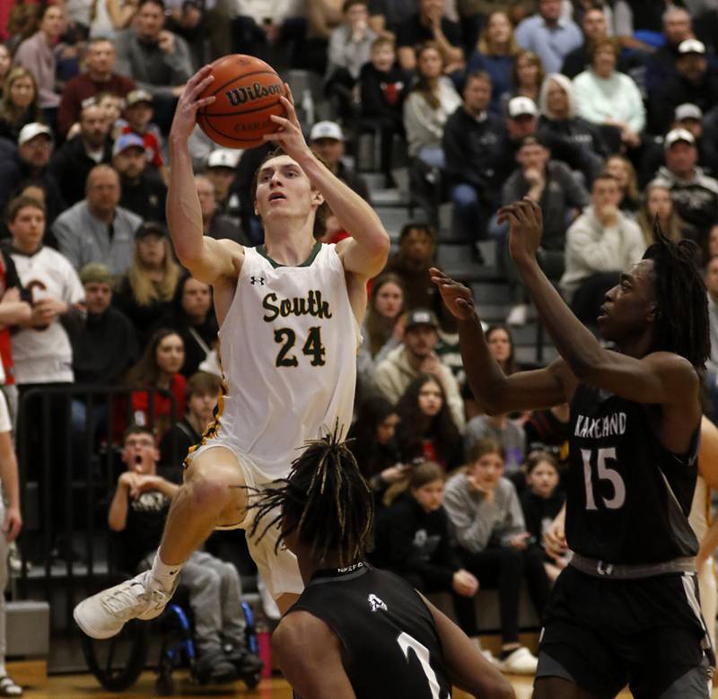 Crystal Lake South's James Carlson drives to the basket against Kaneland's Isaiah Gipson (center) and Evan Ross during the IHSA Class 3A Kaneland Boys Basketball Sectional championship game on Friday, March 1, 2024, at Kaneland High School in Maple Park.