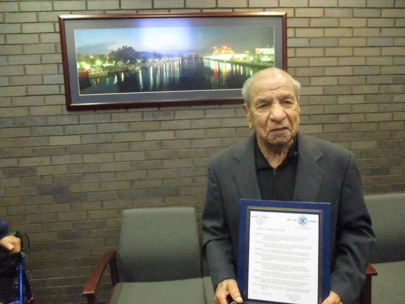 Joe Belman stands with the proclamation issued in his honor by the Joliet City Council on his 100th birthday on Tuesday, Feb. 20, 2022.