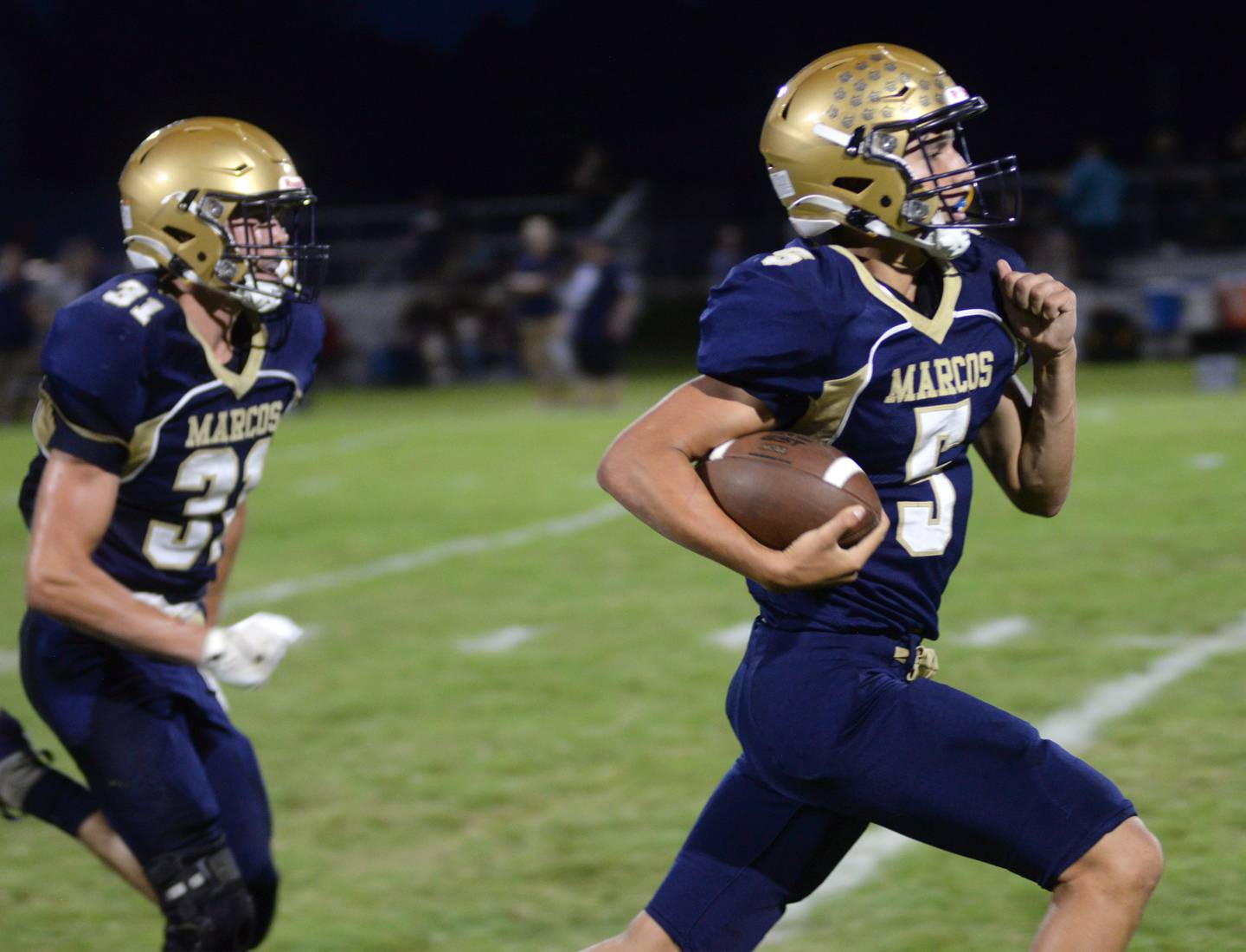 Polo's Gus Mumford (5) breaks loose for a touchdown as Noah Dewey (31) trails during 8-man football action against Hiawatha on Friday, Sept. 13, 2024 in Polo.