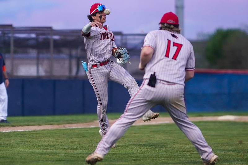 Yorkville's Jailen Veliz (12) fields a bunt and throws to first for an out during a baseball game against Oswego at Oswego High School on Monday, April 29, 2024.