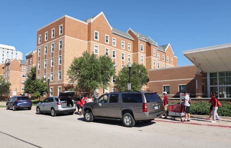 Cars line up in front of New Residence Hall at Northern Illinois University as students move in Thursday, Aug. 19, 2022. Thursday was one of four move-in days for students attending the upcoming school year.