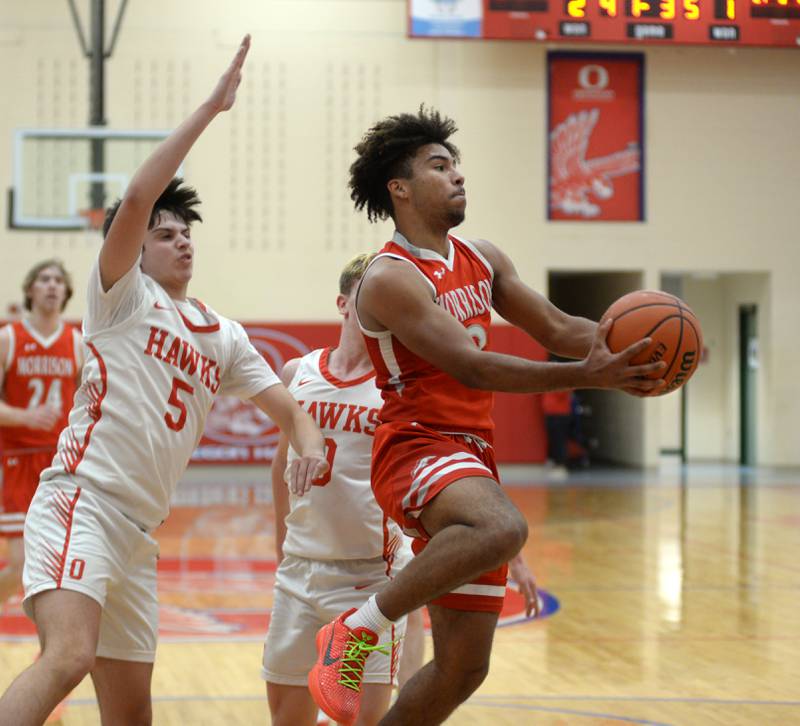 Morrison's DaeShaun McQueen (3) drives to the basket as Oregon's Nole Campos (5) follows during  2A regional action on Monday, Feb. 19, 2024 at the Blackhawk Center in Oregon. The Mustangs downed the Hawks 59-52 to advance to the Prophetstown Regional on Wednesday, Feb. 21.