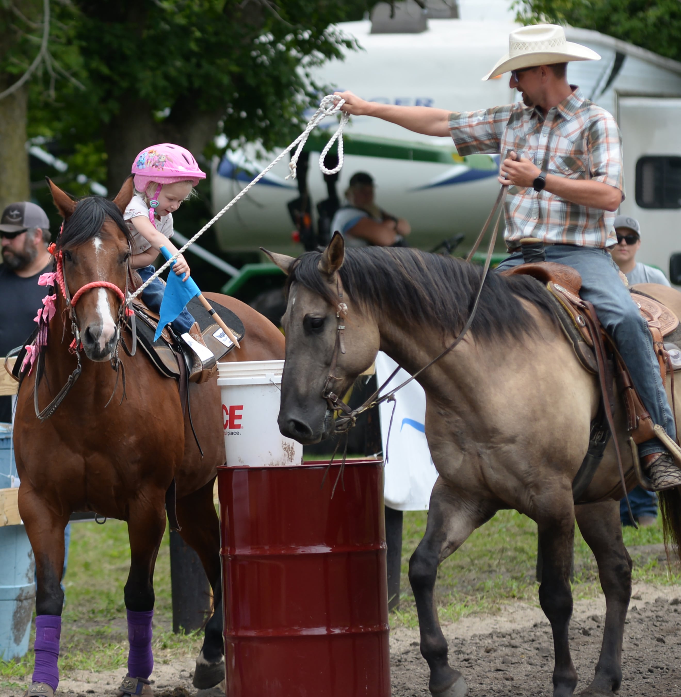 Savannah Chapman, 3, of Earlville, and her horse Sweet Pea, 20, along with her dad Brad and his horse Hank, 6, compete in the Flags Competition at the Rock River Trail & Horseman Association's Grand Opening Show on Saturday, July 20, 2024.