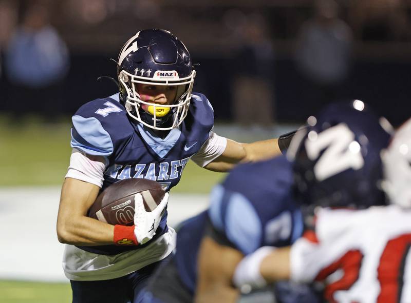 Nazareth's Jake Cestone (7) runs the ball during the varsity football game between Benet and Nazareth academies on Friday, Oct. 18, 2024 in La Grange Park.