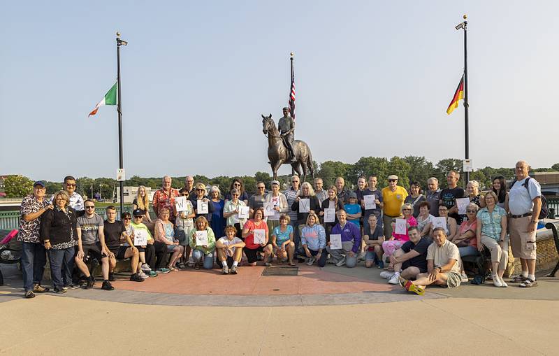 Herzberg/Elster delegates and their Dixon Sister City's host families display signs Friday, July 26, 2024, for a German friend who was unable to make the trip.