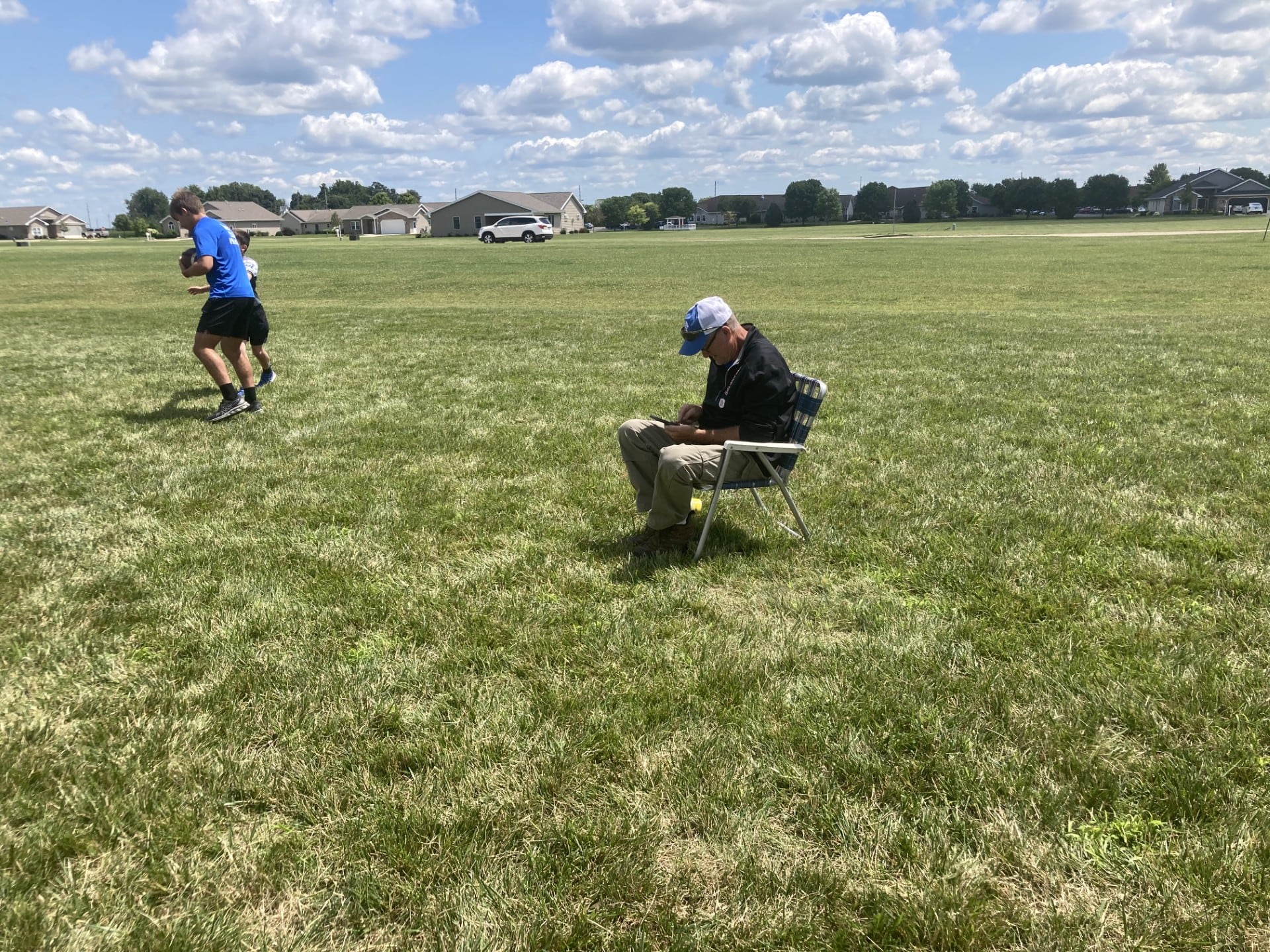 Tom Pearson, father of Princeton head coach, has a good seat for the controlled practice/scrimmage at Little Siberia Field on Thursday, July 18.