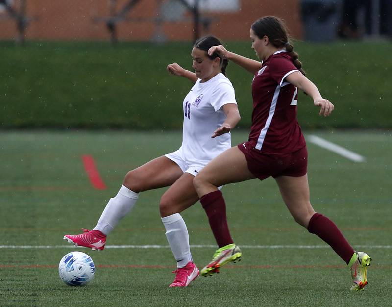 Hampshire's Hope Lorbiecki tries to control the ball in front of Prairie Ridge's Ava Gertz during a Fox Valley Conference soccer game on Tuesday, April 16, 2024, at the MAC Athletic Complex in Crystal Lake.