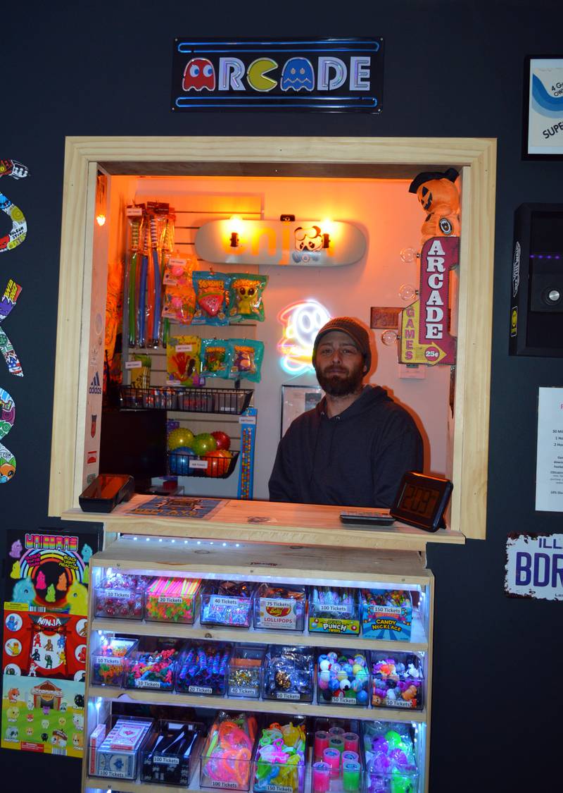 Replays Arcade owner Robert Lewis sits at the counter near the entrance of the game room. Located at 94 S. Peoria Ave., Dixon, Replays Arcade has more than 20 classic arcade game machines and an air hockey table.