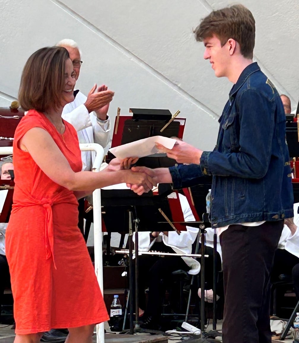 Daniel Clements receiving the scholarship award certificate