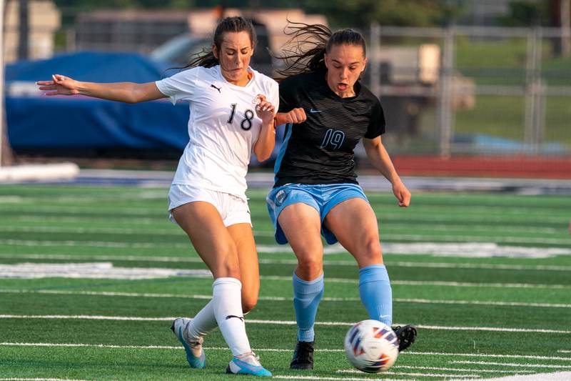 Wheaton Warrenville South's Ella McClatchy (18) challenges St. Charles North's Laney Stark (19) for the ball during the Class 3A girls soccer regional final at St. Charles North High School on Friday, May 19, 2023.