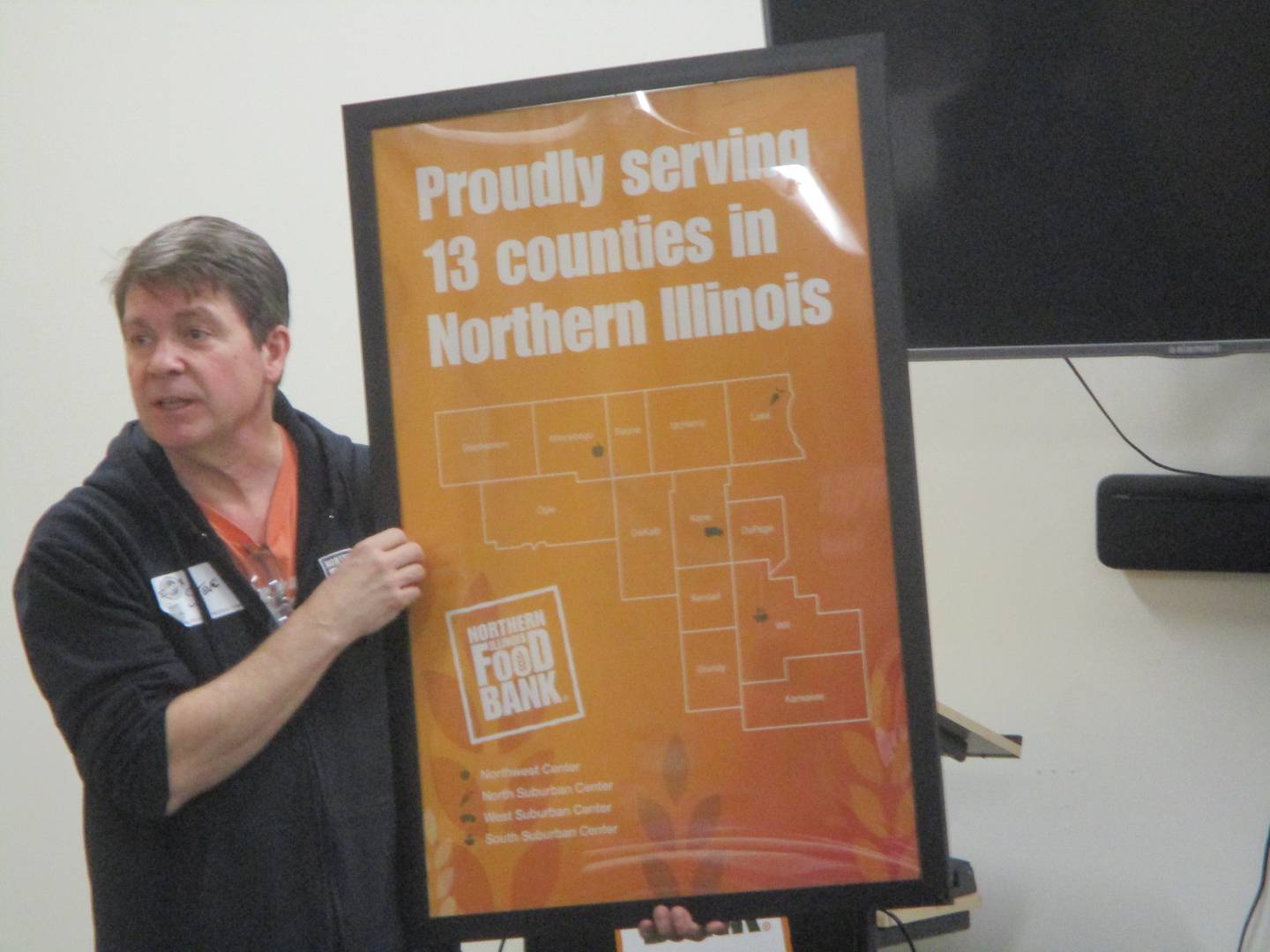 Steven Harold, processing coordinator at the Northern Illinois Food Bank South. Suburban Center in Joliet, tells volunteers from Northwestern Medicine on Saturday how their donations and volunteerism helps serve people in need. Feb. 24, 2024.