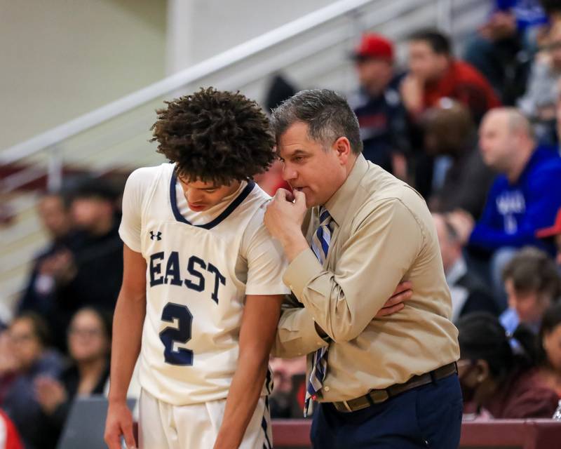 Oswego East's head coach Ryan Velasquez gives instructions to Bryce Shoto (2) during Class 4A Lockport Regional final game between West Aurora at Oswego East.  Feb 24, 2023.