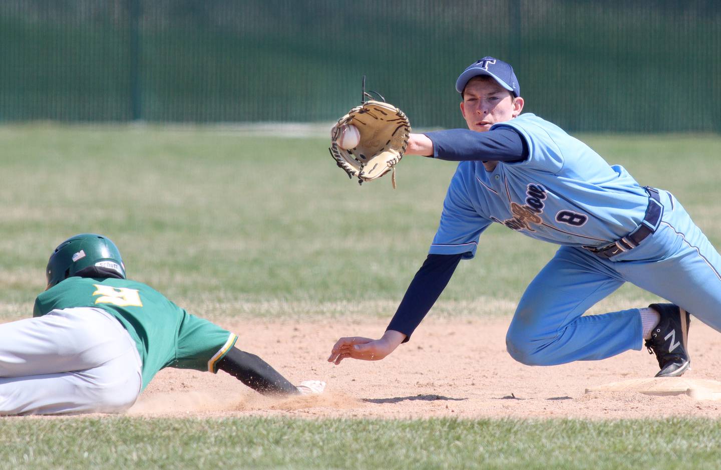 Cary-Grove’s Peyton Seaburg, right, snags the toss before tagging out Crystal Lake South’s Edgar Camacho on a pick-off play in varsity baseball at Cary on Saturday.