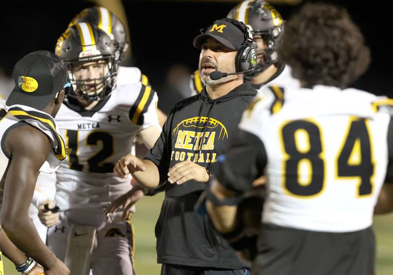 Metea Valley head coach John Parpet talks to his team during their game Friday, Sept. 16, 2022, at DeKalb High School.