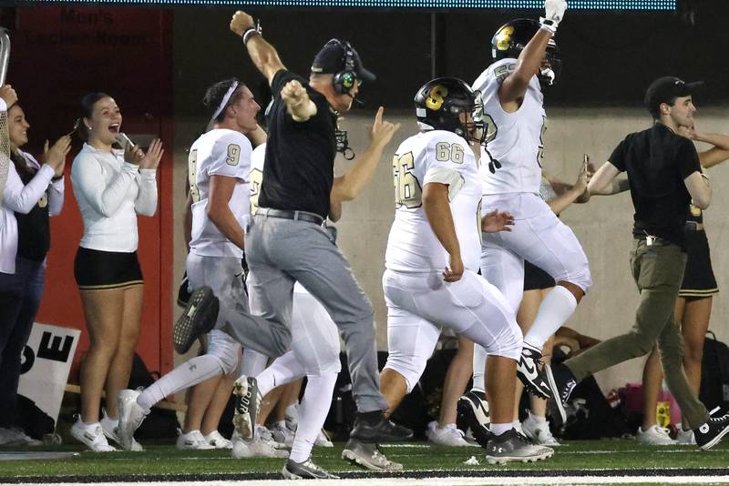 Sycamore head coach Joe Ryan celebrates as his team scores on a late touchdown to take the lead over DeKalb Friday, Aug. 30, 2024, during the FNBO Challenge at Huskie Stadium at Northern Illinois University.