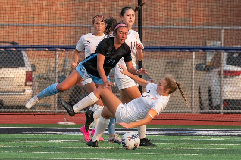 St. Charles North's Bella Najera (17) and Wheaton Warrenville South's Carolyn Harvey (25) collide during the Class 3A girls soccer regional final at St. Charles North High School on Friday, May 19, 2023.