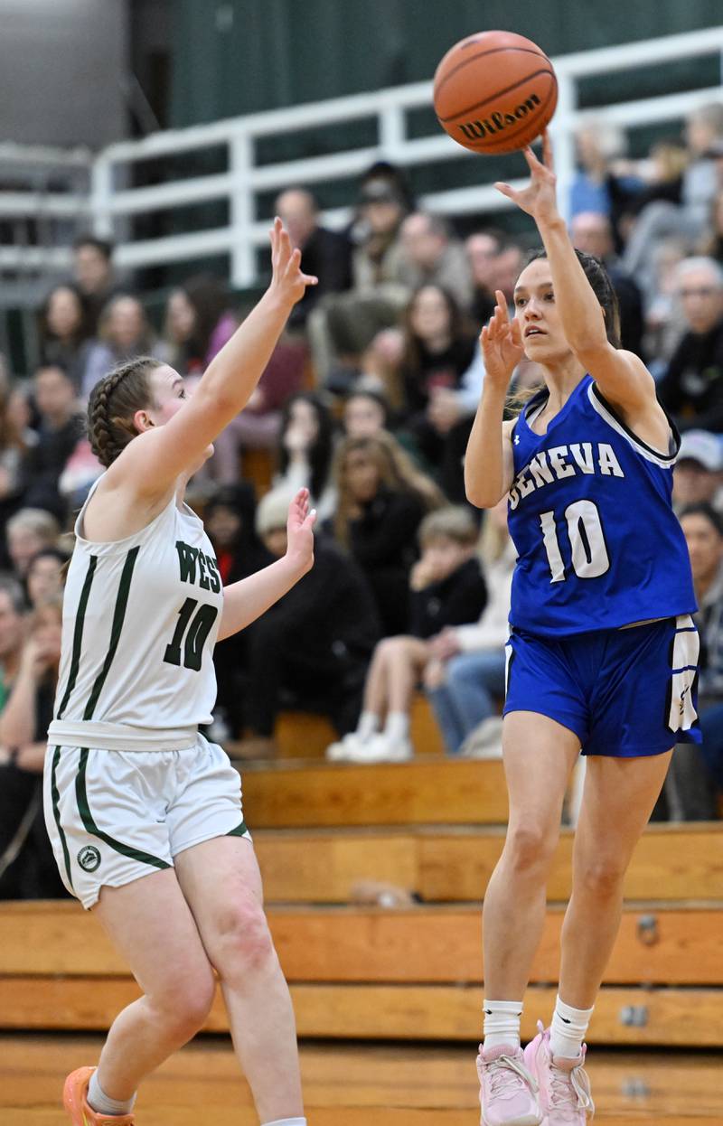 Geneva’s Peri Sweeny, right, passes as Glenbard West’s Julia Benjamin closes in on defense during the Glenbard West Class 4A girls basketball regional final on Thursday, Feb. 15, 2024 in Glen Ellyn.