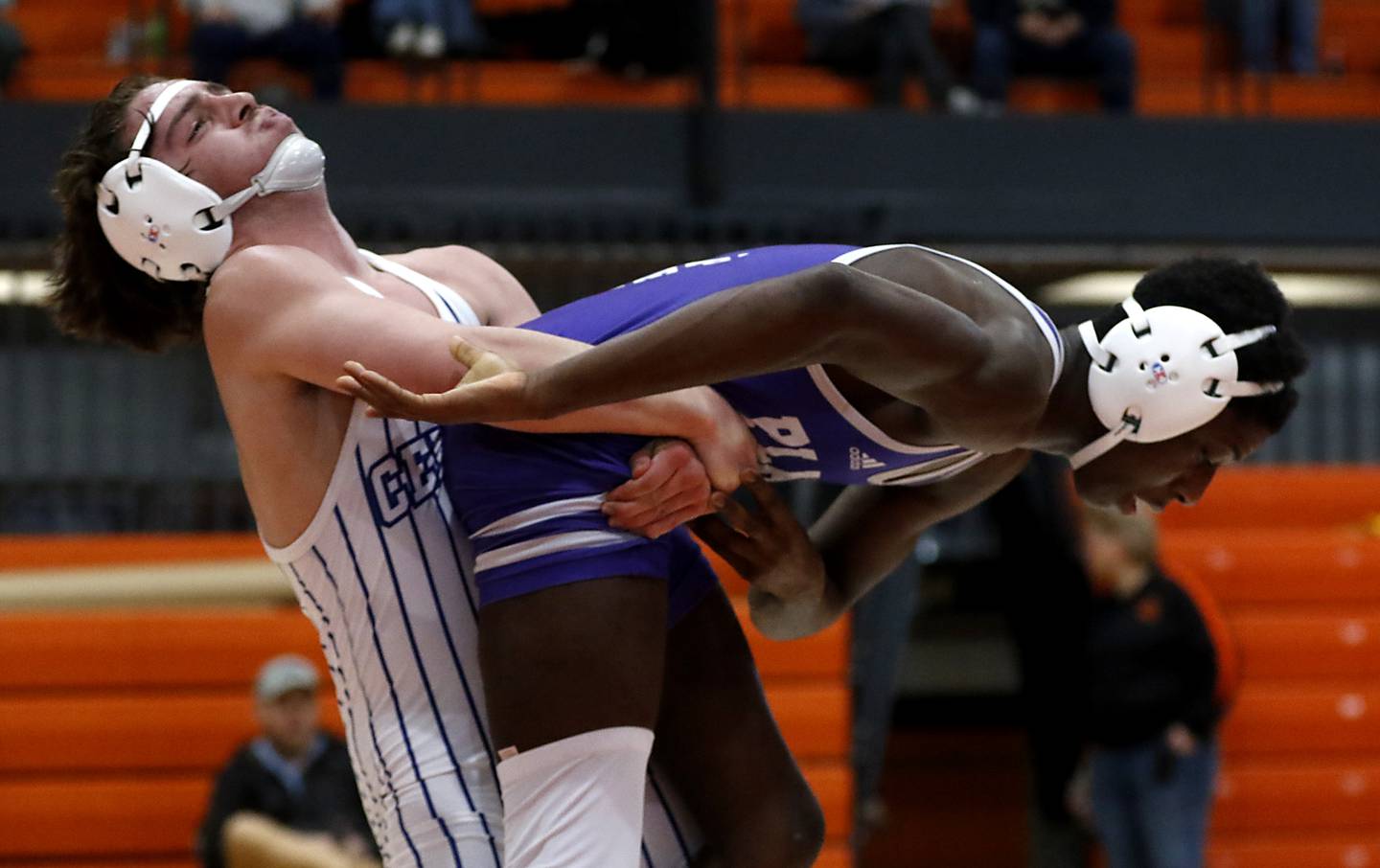 Burlington Central’s Austin Lee lifts Plano’s Antoine Gilford  during the 138-pound championship match of a the IHSA 2A Crystal Lake Central Wrestling Regional on Saturday, Feb. 3, 2024, at Crystal Lake Central High School.