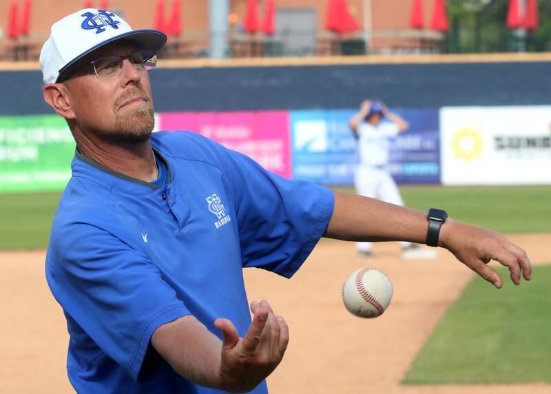 Newman head baseball coach Kenny Koerner sends a foul ball back to the dugout during the Class 2A semifinal game on Friday, May 31, 2024 at Dozer Park in Peoria.