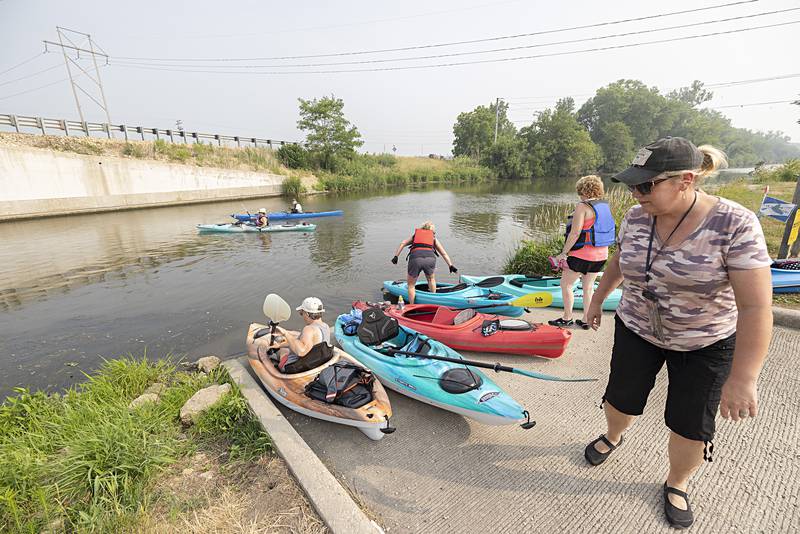 Yak-Yak Sister Pam Pyron helps launch a fellow sister Wednesday, June 28, 2023 during the group’s regular weekly float on the canal.