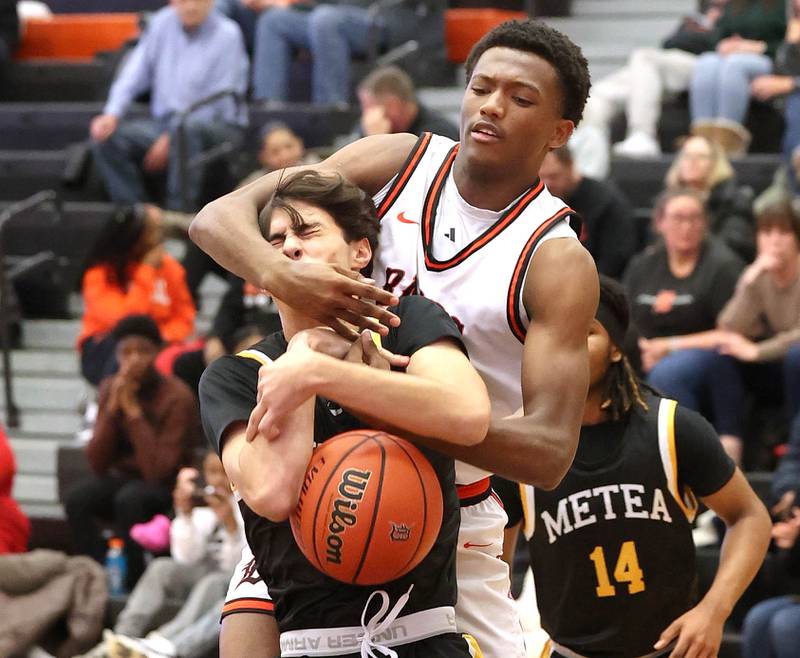 DeKalb’s Justin O’Neal and Metea Valley's Kyle Bucher go after a rebound during their game Friday, Jan. 19, 2024, at DeKalb High School.