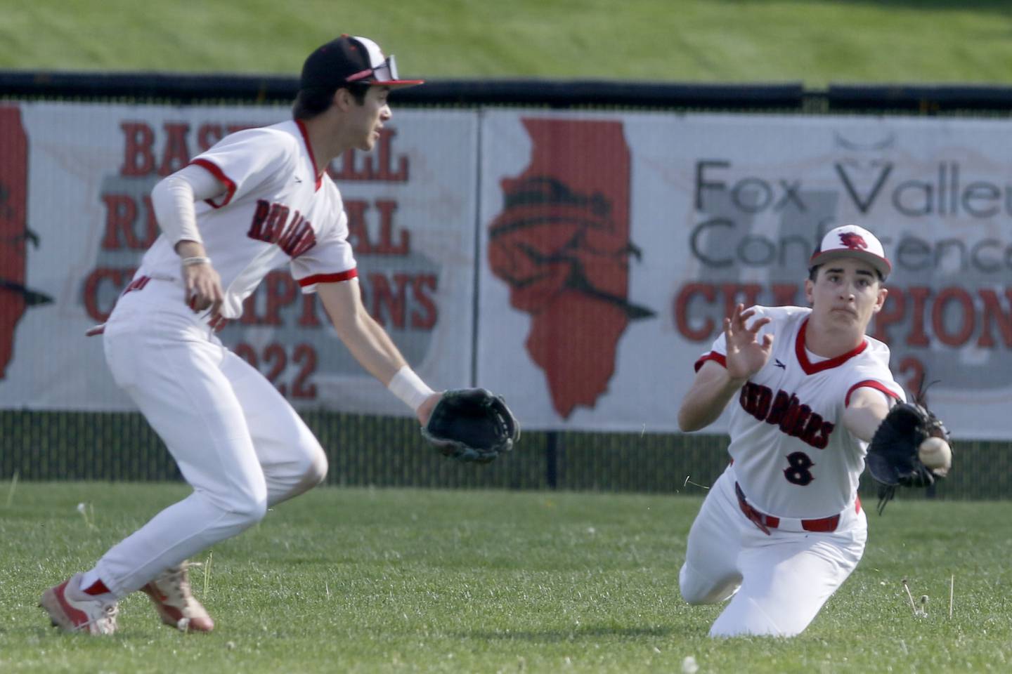 Huntley's Ryan Dabe tries to make a catch in front of his teammate, Griffin Goldstein, during a Fox Valley Conference baseball game against Burlington Central on Friday, May 10, 2024, at Huntley High School.