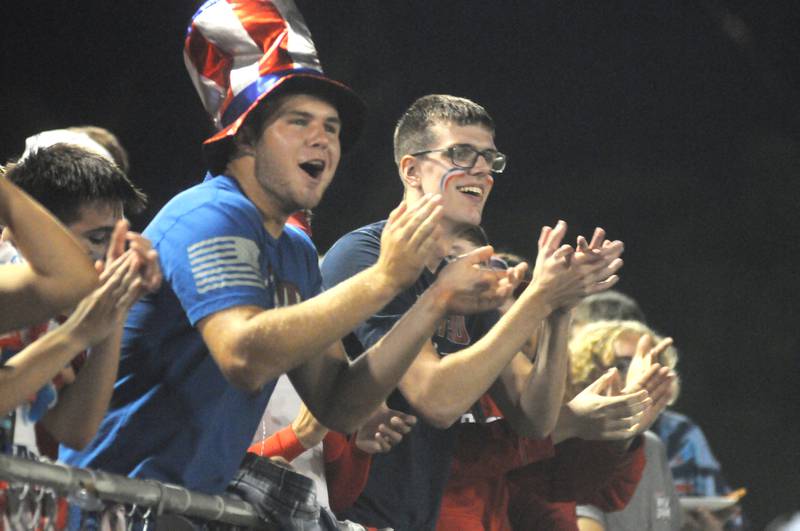 Streator fans Landon Muntz (left) and Layton Finney cheer as the Bulldogs take the field at Doug Dieken Stadium on Friday, Sept. 22, 2023.