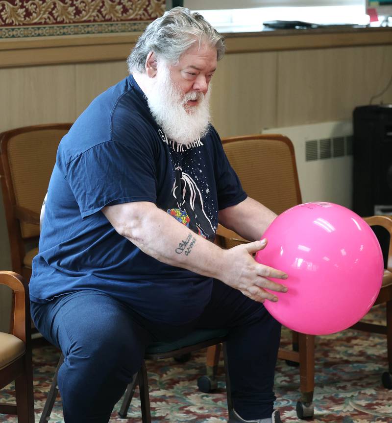 Barb City Manor resident Greg Miller makes a catch during an activity Tuesday, July 2, 2024, at the retirement home in DeKalb. Barb City Manor celebrated its 45th anniversary earlier this year.