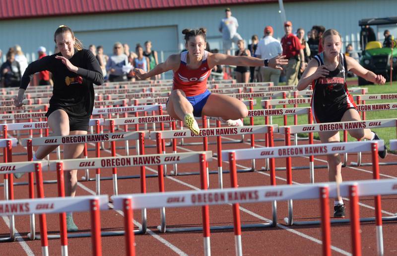 Oregon's Rylie Robertson (center) leads in the 100 hurdles at the 1A Oregon Sectional on Friday. May 10, 2024. Robertson won the race in 17.26 seconds to qualify for the state finals at Eastern Illinois University in Charleston. Also pictured are Lena-Winslow's Molly Amendt (left) and Forreston-Polo's Courtney Grobe (right).