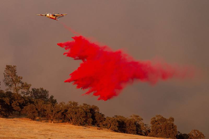 An air tanker drops retardant while battling the Aero Fire in the Copperopolis community of Calaveras County, Calif., Monday, June 17, 2024. (AP Photo/Noah Berger)