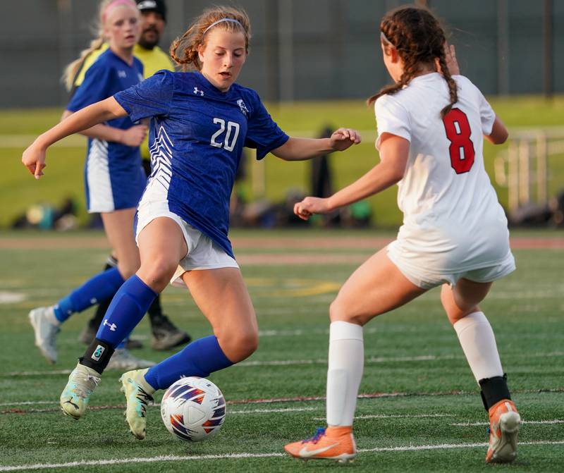 Geneva’s Caroline Madden (20) plays the ball against Glenbard East's Makenna Gibbons (8) during a Class 3A Glenbard East Regional semifinal soccer match at Glenbard East High School in Lombard on Tuesday, May 14, 2024.