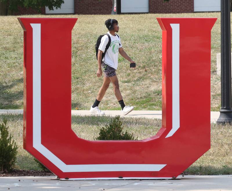 A Northern Illinois University student walks past the NIU sculpture Thursday, Sept. 12, 2024, on campus at NIU in DeKalb.