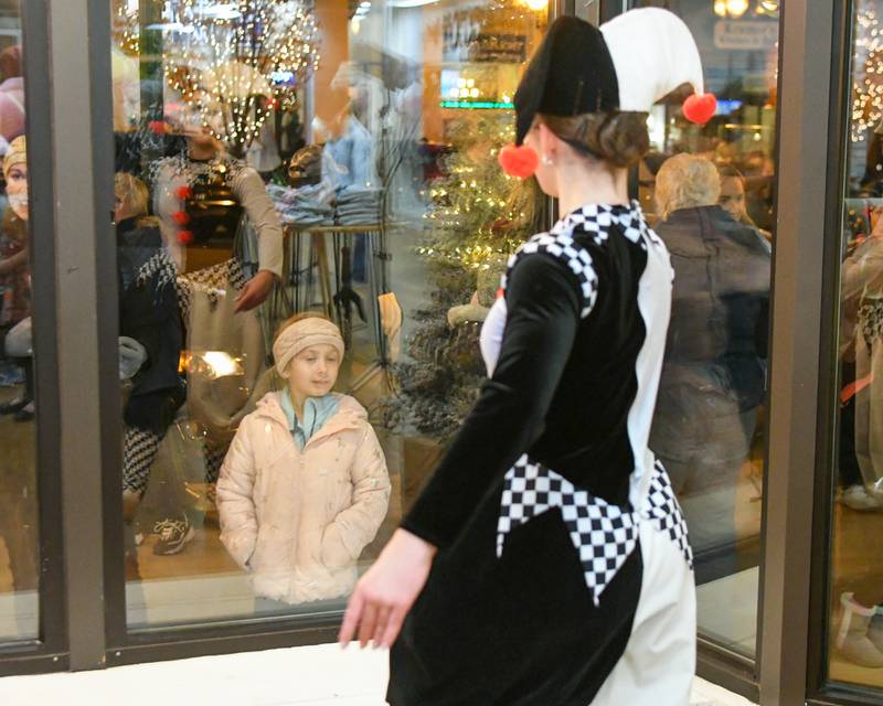 Gabriella Foley, 6, of Sycamore watches a dancer in the window during the Sycamore Chamber of Commerce's annual Moonlight Magic event held in downtown Sycamore on Friday, Nov. 17, 2023.