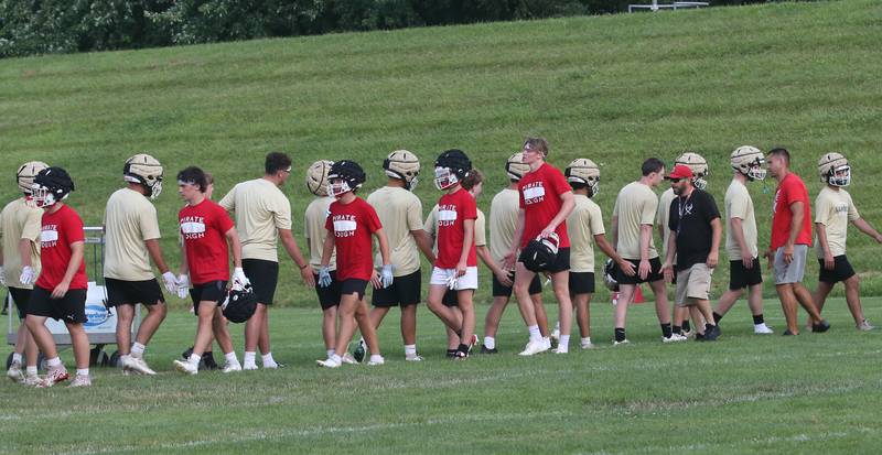 Members of the Ottawa and St. Bede football teams shake hands after playing in a 7-on-7 meet on Wednesday, July 24, 2024 at Ottwaa High School.