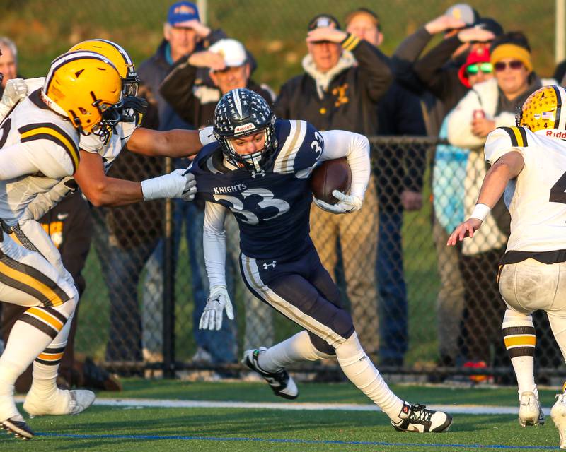 IC Catholic Prep's Joey Gliatta (33) is grabbed by the sidelines during Class 4A third round playoff football game between St Laurence at IC Catholic Prep.  Nov 11, 2023.