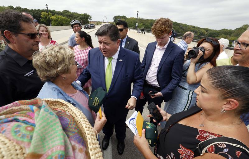 Illinois Gov. JB Pritzker chats with people after the ribbon cutting for the Longmeadow Parkway over the Fox River Thursday, Aug. 29, 2024 in Algonquin.