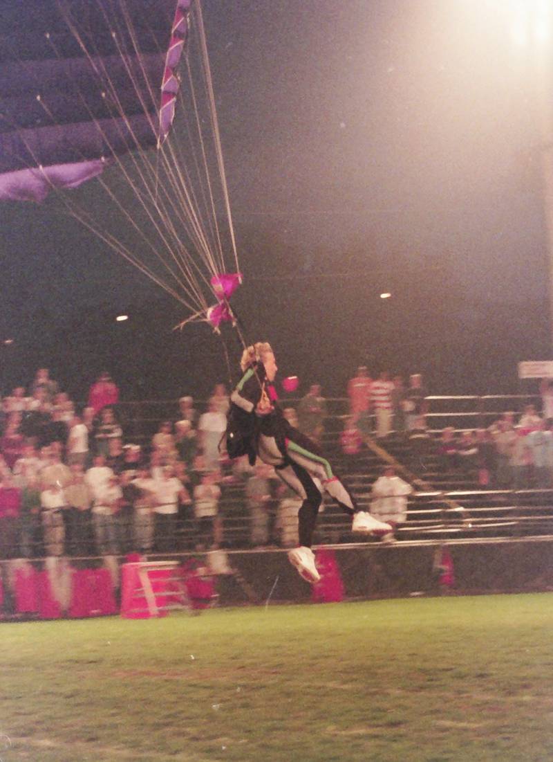 A skydiver brings in the game ball as he parachutes onto King Field during the 100th year Gridiron Game on Friday, Sept, 25, 1998 at King Field.