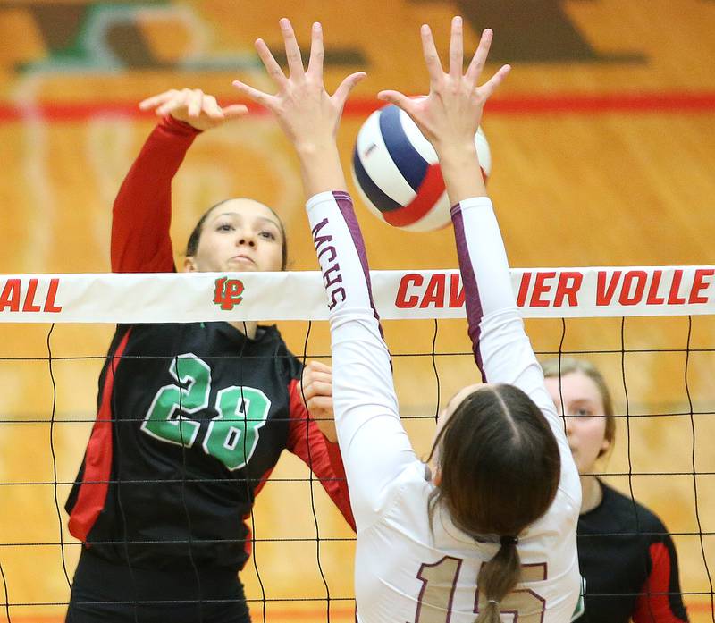 L-P's Ava Currie spikes the ball past Morris's Lily Hansen in the Class 3A Regional game on Thursday, Oct. 26, 2023 at Sellett Gymnasium.