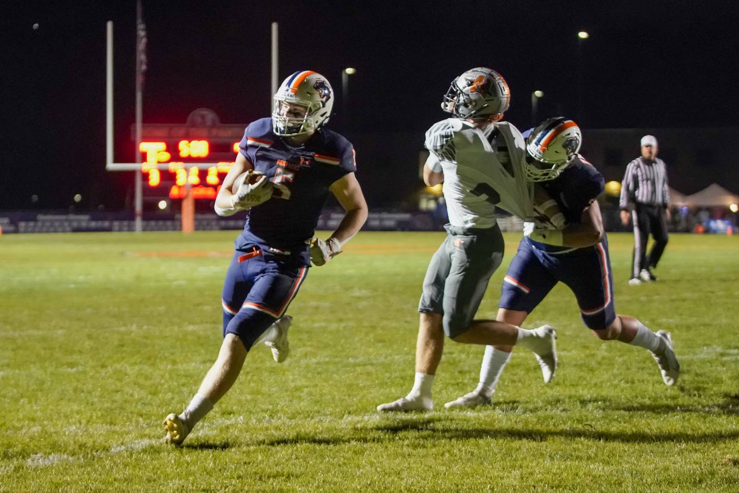 Oswego’s Carson Cooney (5) carries the ball for a touchdown against Minooka during a football game at Oswego High School on Friday, October 18, 2024.