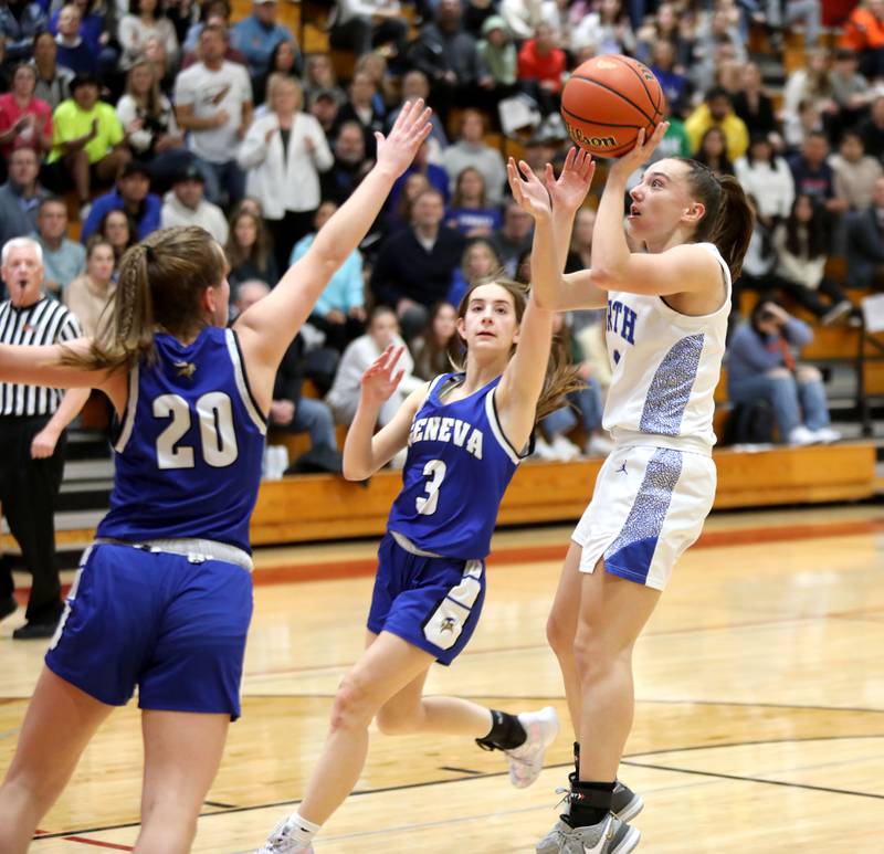 St. Charles North’s Laney Stark shoots the ball over Geneva’s Caroline Madden (left) and Hope Ieler (center) during a Class 4A Batavia Sectional semifinal game on Tuesday, Feb. 20, 2024.