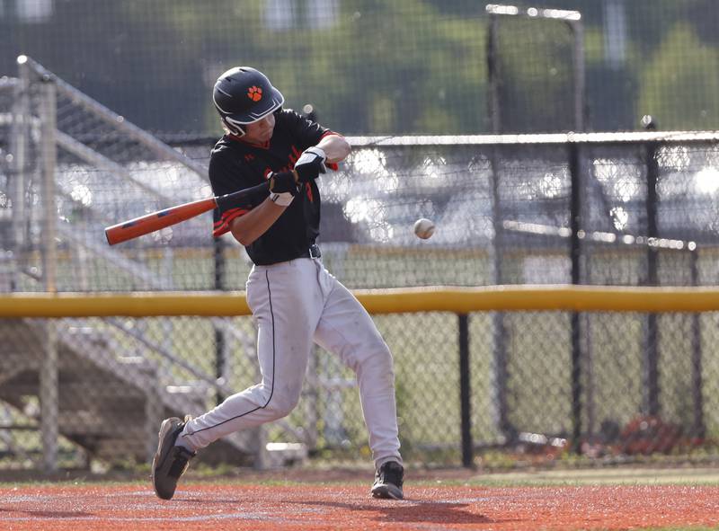 Wheaton Warrenville South's Aidan Quartz (21) makes contact during the Class 4A York regional semi-final between Wheaton Warrenville South and St. Charles East in Elmhurst on Thursday, May 23, 2024