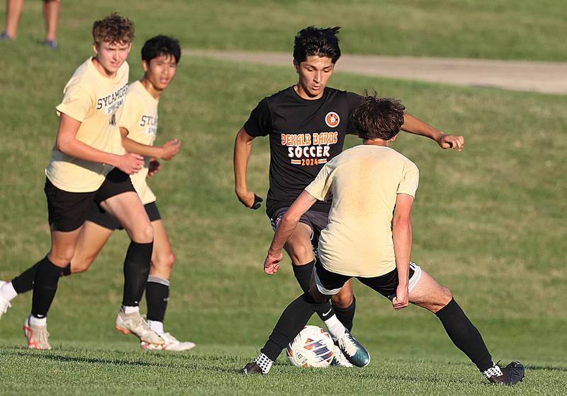 DeKalb’s Mauricio Jasso tries to get by a Sycamore player Wednesday, July 17, 2024, during their scrimmage game at Sycamore High School.