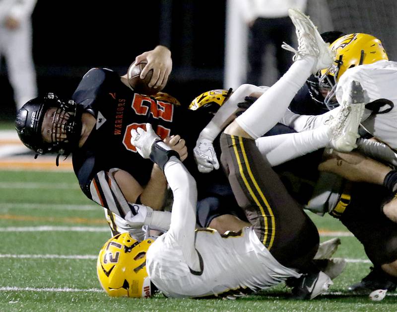 McHenry's Conner McLean is tackled by Jacobs' Cooper Gulgren during a Fox Valley Conference football game on Friday, Oct. 18, 2024, at McKracken Field in McHenry.