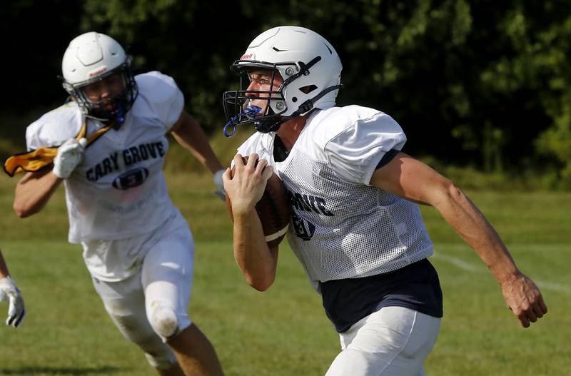 Quarterback Peyton Seaburg runs with the ball during football practice Tuesday, Aug. 20, 2024, at Cary-Grove High School, as the 2023 IHSA Class 6A champions look to defend their title.