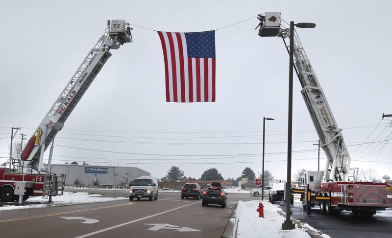 A large American flag hangs over Airport Road near the Sycamore Park District Community Center Saturday, Jan. 6, 2024, in honor of Sycamore firefighter/paramedic Bradley Belanger. Belanger, 45, who worked with the Sycamore Fire Department for more than two decades, died Friday, Dec. 22, after a yearlong battle with cancer.